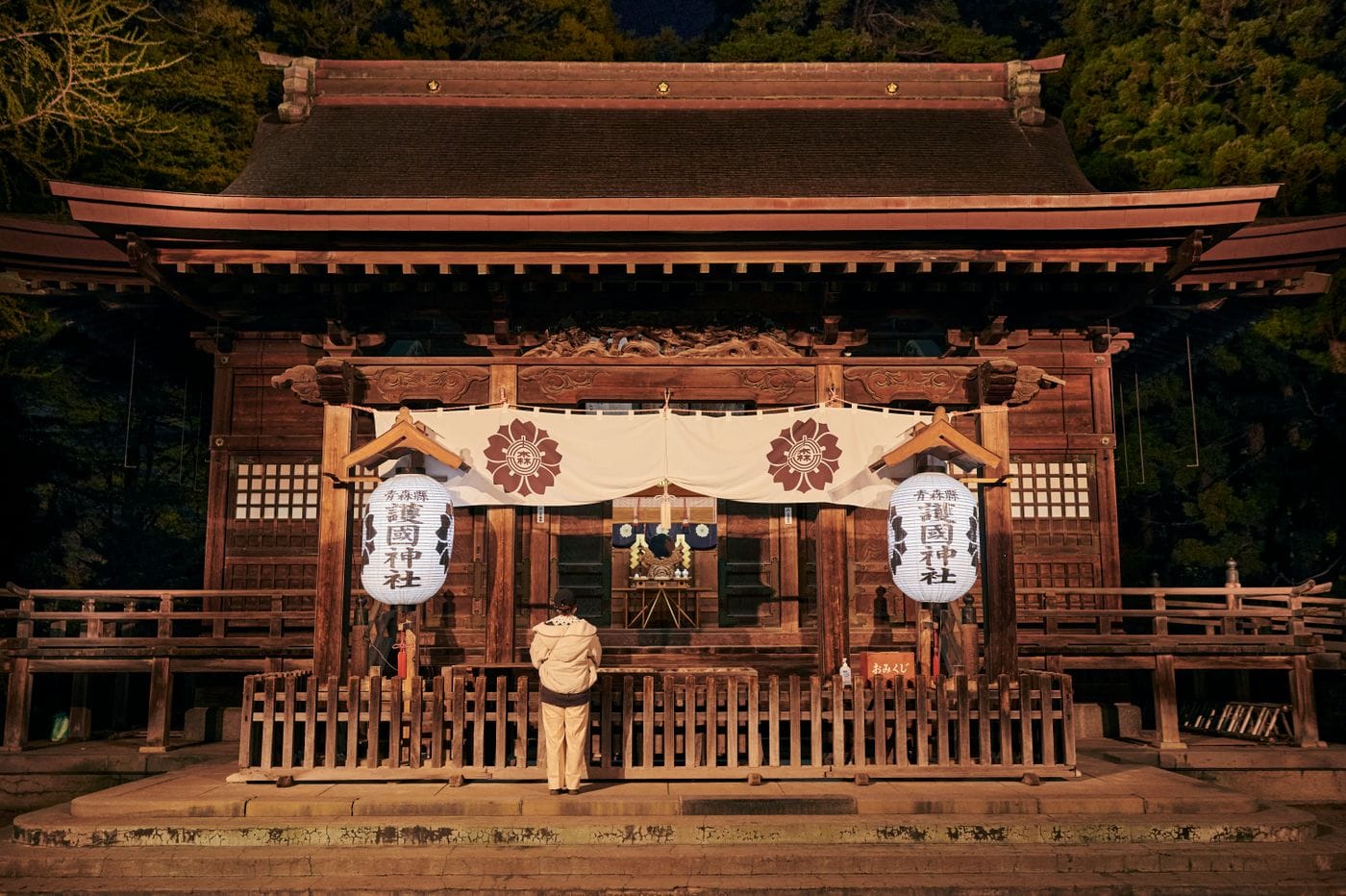 A peaceful scene at a traditional Japanese shrine at night, capturing the essence of cultural spirituality.