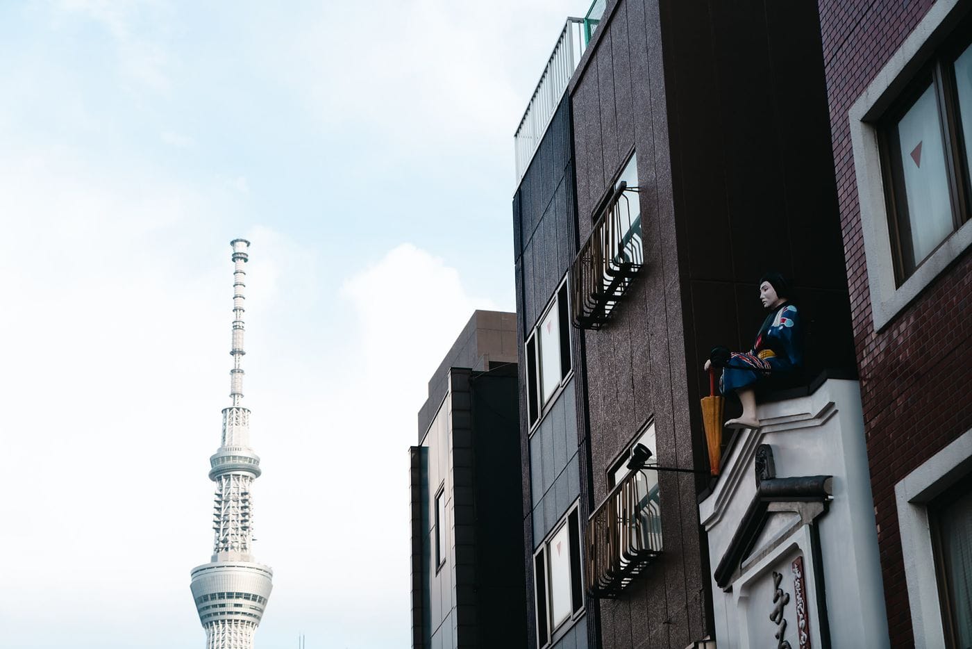 View of Tokyo Skytree beside traditional urban architecture in Tokyo, Japan.