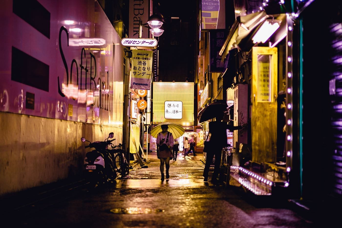 Explore Tokyo's vibrant nightlife captured in a glowing, rain-soaked alleyway, showcasing urban charm and colorful street lights.