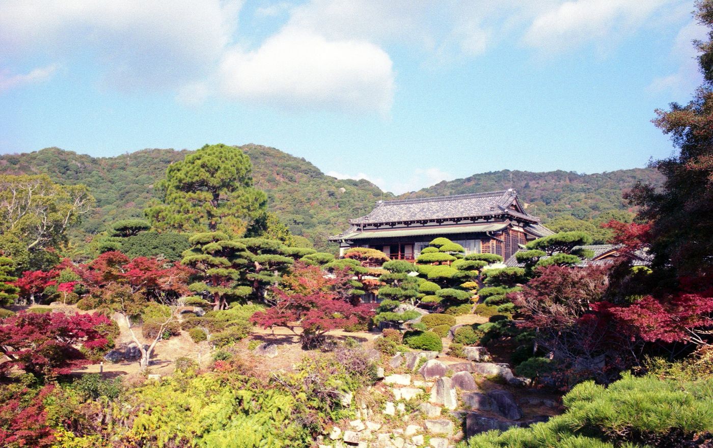 Scenic view of a traditional Japanese garden with vibrant autumn colors in Hōfu, Yamaguchi, Japan.