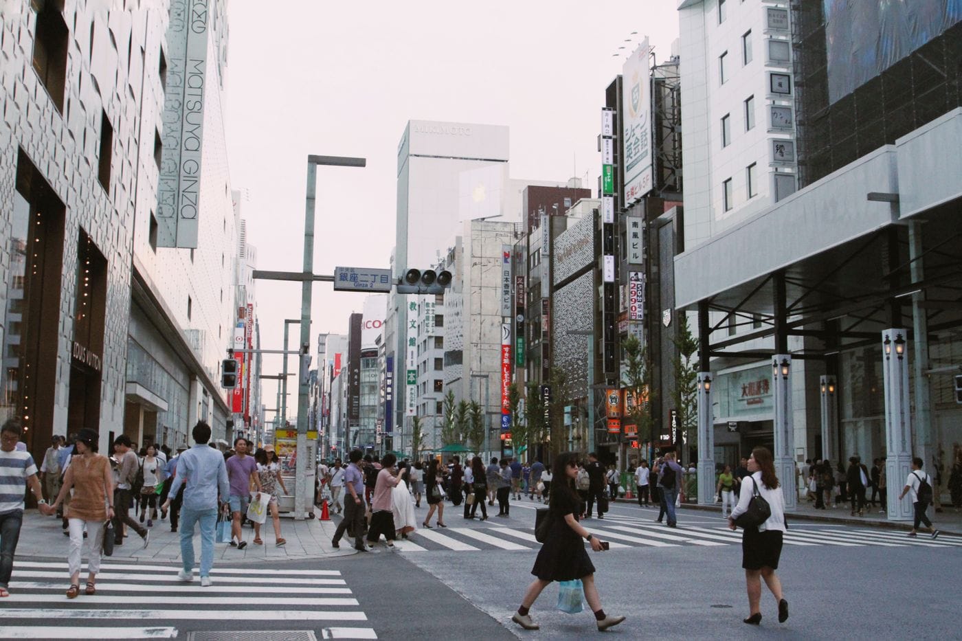 Crowds of people crossing a busy intersection in Tokyo, Japan, showcasing urban city life.