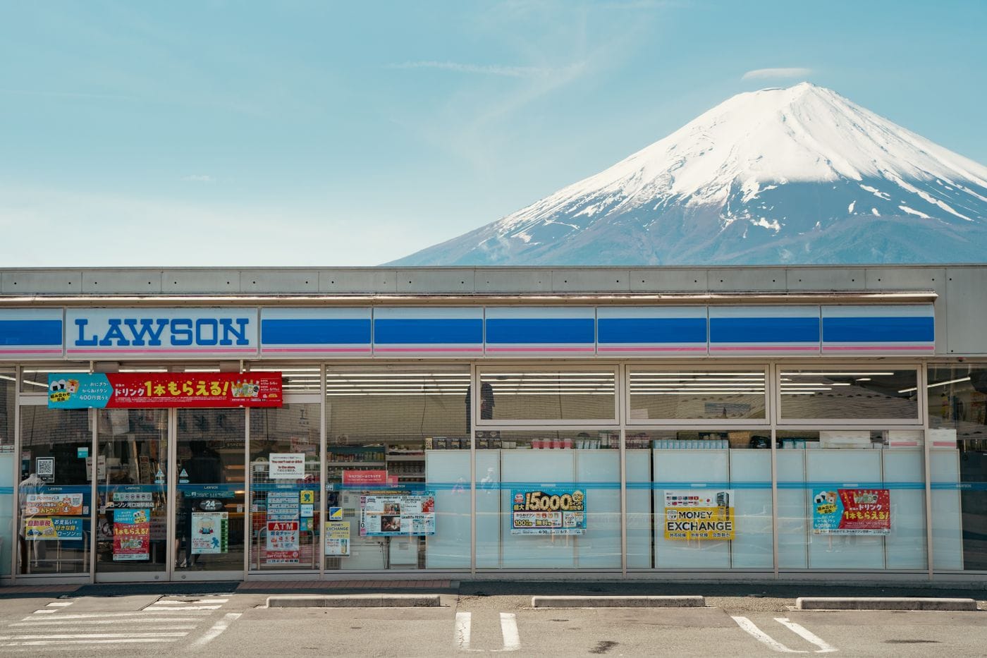 A Lawson convenience store with Mount Fuji in the background, showcasing Japan's iconic landscape.