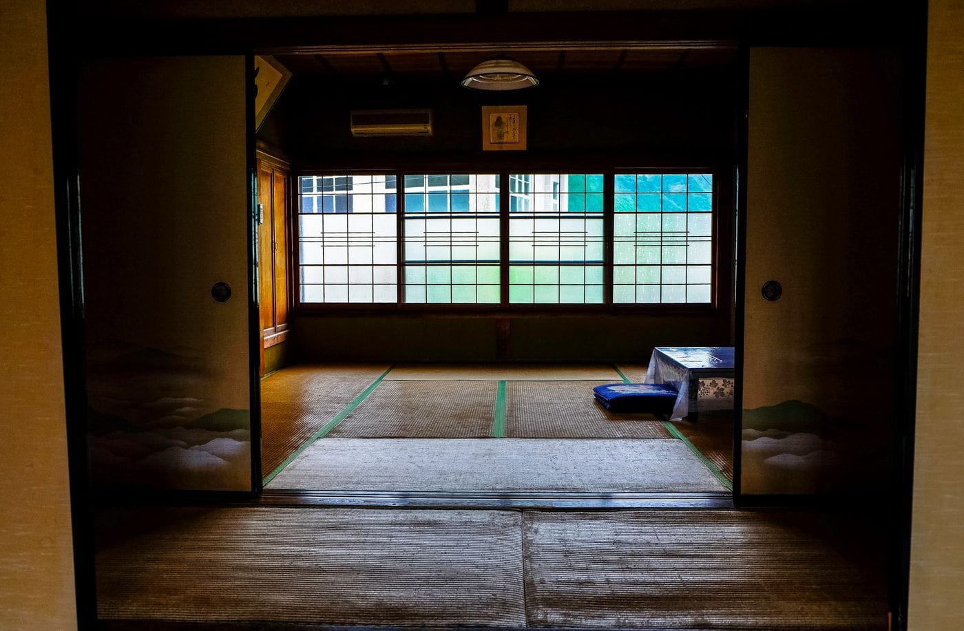 Serene interior of a traditional Japanese ryokan with tatami flooring and sliding doors